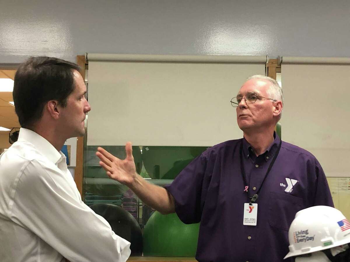 Congressman Jim Himes, left, listens at Riverbrook Regional YMCA CEO Bob McDowell discusses the Y’s renovation project on Aug. 6.