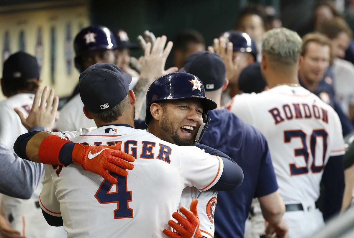 Houston Astros Yuli Gurriel (10) celebrates with George Springer (4) after hitting a three-run home run off of Colorado Rockies starting pitcher Peter Lambert during the first inning of an MLB baseball game at Minute Maid Park, Wednesday, August 7, 2019.