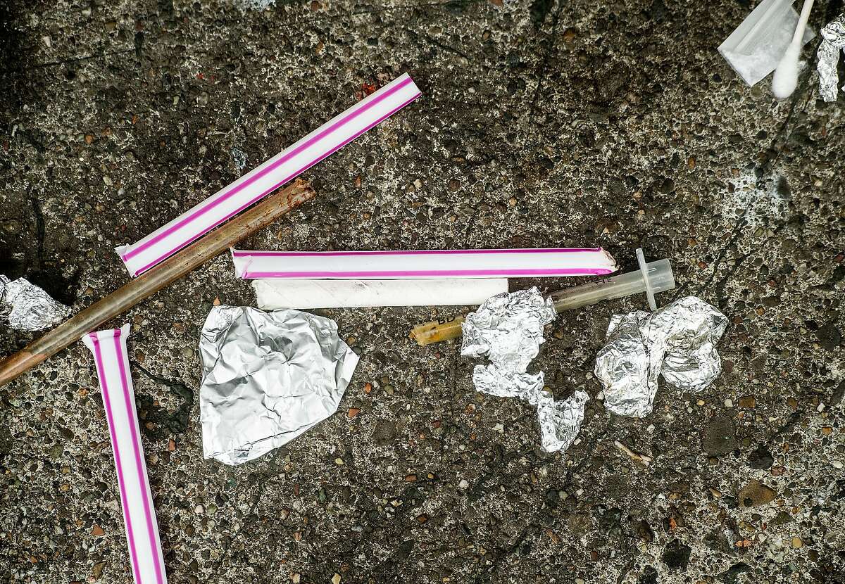 Drug paraphernalia removed from a woman's bag rests on Hyde St. following an arrest on Wednesday, Aug. 7, 2019, in San Francisco.