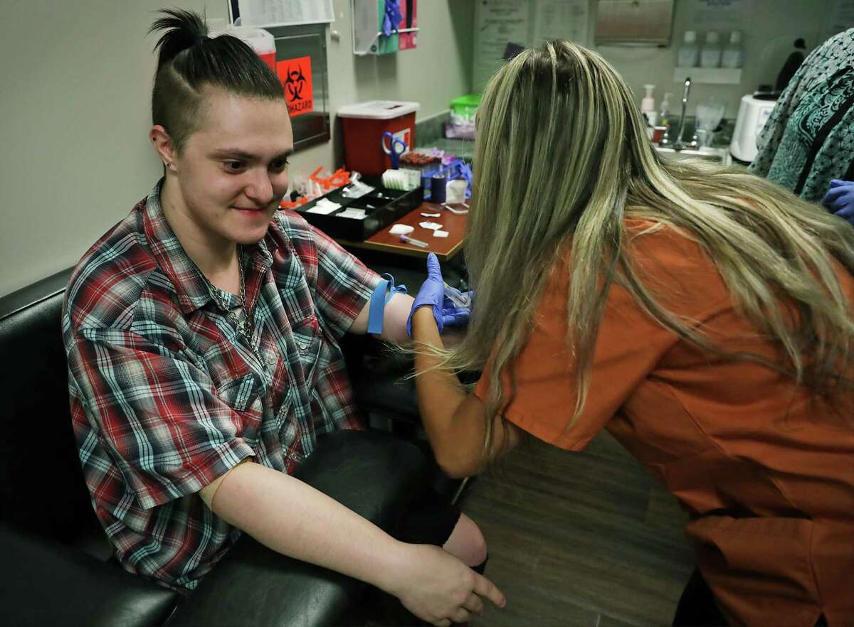 Xavier Hubbard, left, has blood drawn by nursing student Alyssa Binz for a test at the Pride Community Clinic run by UT Health San Antonio students, on Wednesday, July 24, 2019. The clinic is an extension of the Alamo Area Resource Center LGBT Health Equity Clinic.
