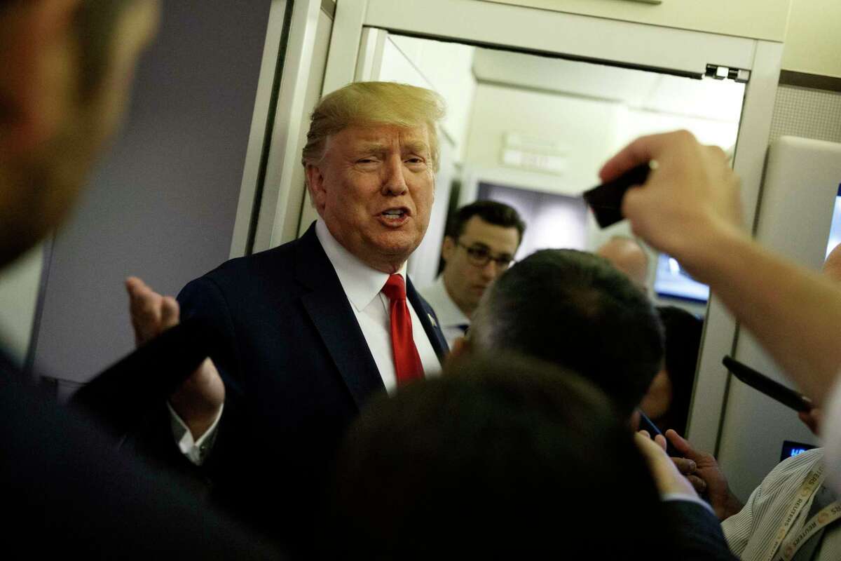 President Donald Trump talks to reporters aboard Air Force One after visiting Dayton, Ohio and El Paso, Texas.