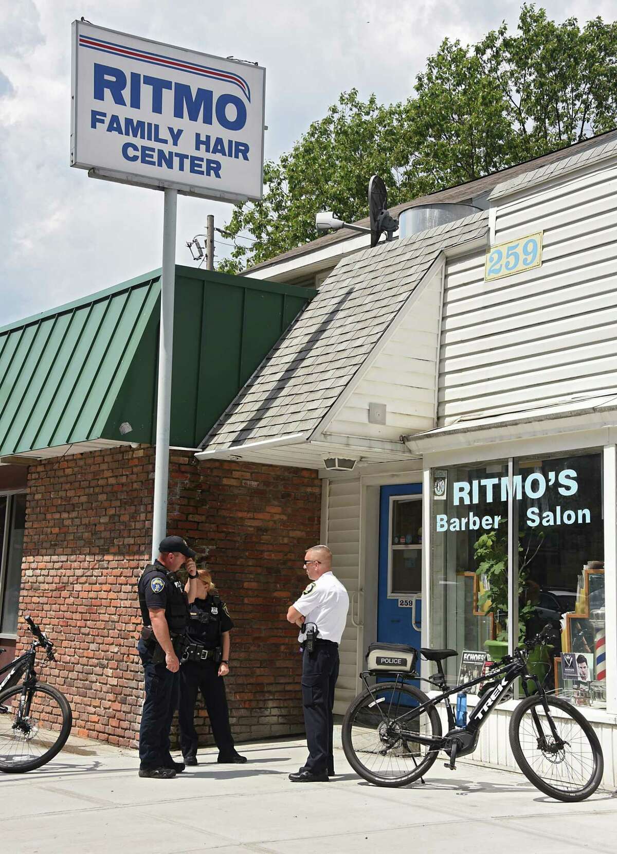 Police investigate the scene where two men armed with a gun took money from customers at Ritmo's Barber Salon at 259 New Scotland Ave. on Thursday, Aug. 8, 2019 in Albany, N.Y. (Lori Van Buren/Times Union)
