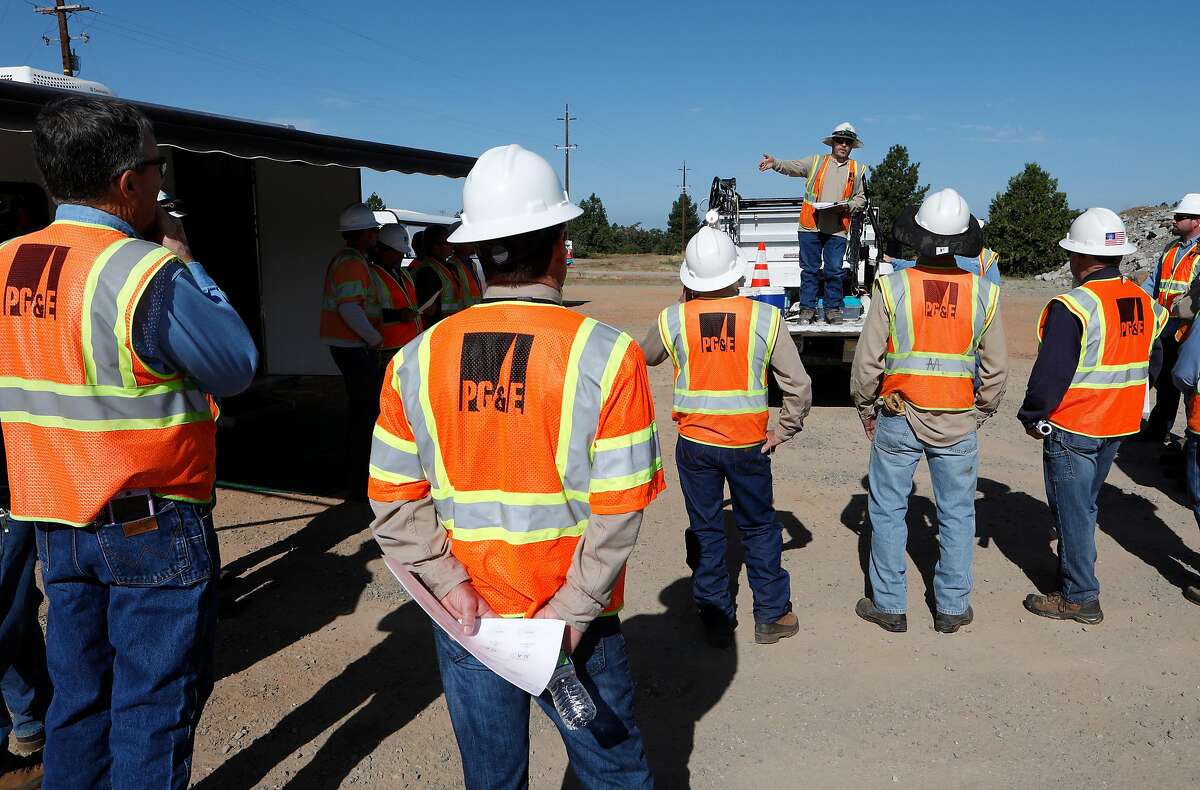 PG&E's Aaron Rubio, begins the day meeting the crews to discuss the day's events, as they prepare to perform a public safety power shutoff drill around Foresthill, Ca. on Thurs. August 8, 2019, Helicopters and trucks, are used in a trial run for how it will inspect power lines before turning them on after a shut down.