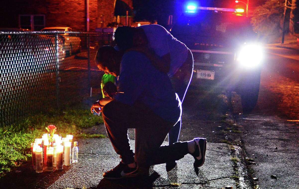 Family members gather to hold a vigil for the stabbing victim at 39 Faifield Ave. Thursday August 8, 2019, in Norwalk, Conn.