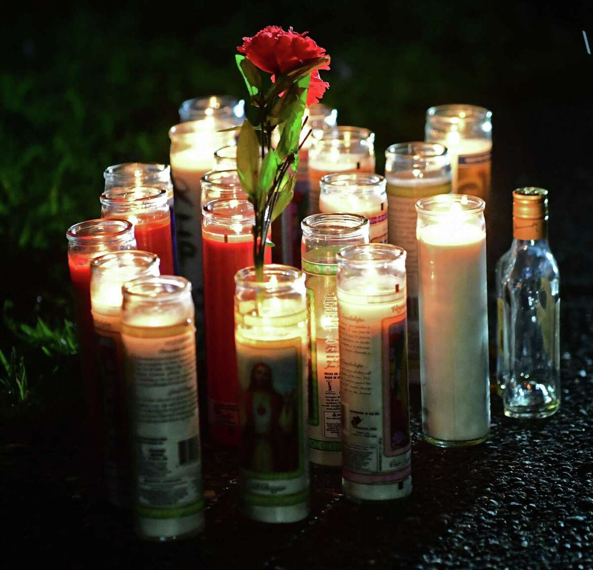 Family members gather to hold a vigil for the stabbing victim at 39 Faifield Ave. Thursday August 8, 2019, in Norwalk, Conn.