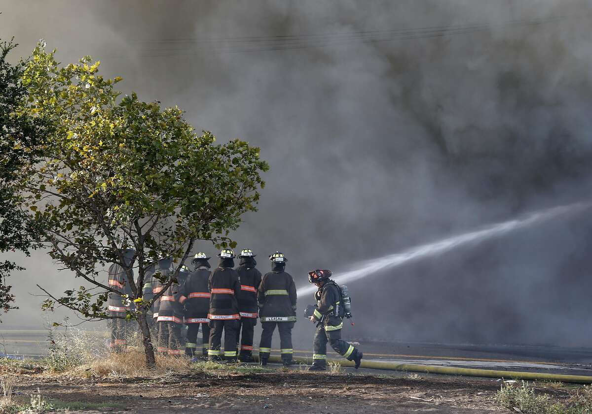 Firefighters battle a 3-alarm fire in a warehouse at 23rd Avenue and E. 11th Street in Oakland, Calif. on Friday, Aug. 9, 2019.
