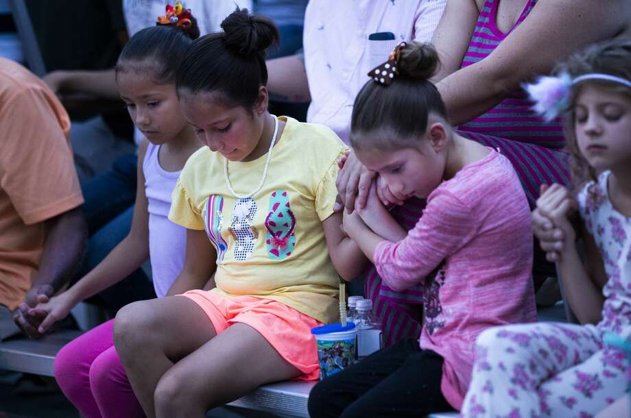 A group of girls hold hands during a prayer service in memory of the victims of the El Paso shooting. The event was organized by the Immanuel Church. Photo: Marie D. De Jesús/Staff Photographer