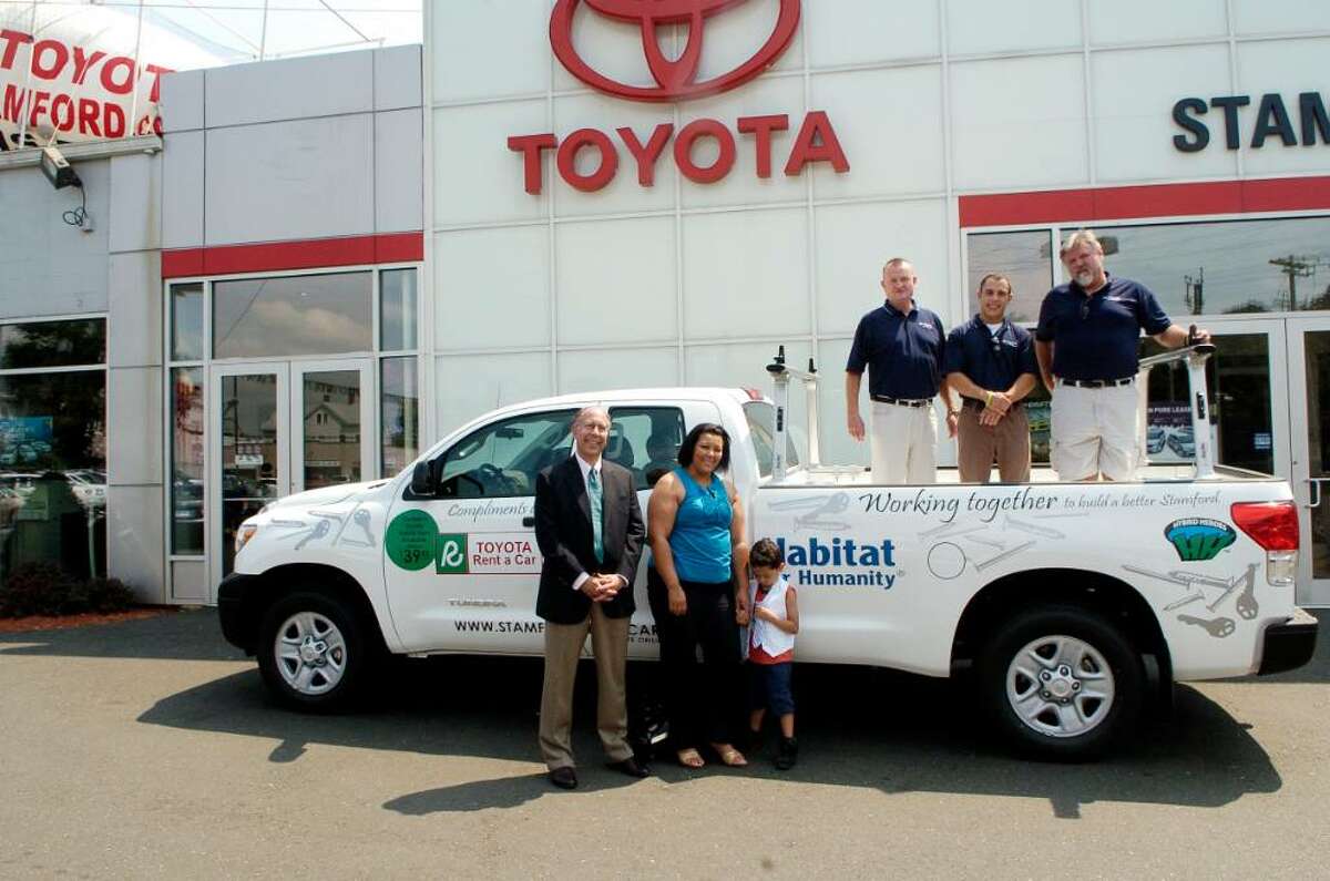 Toyota of Stamford presents Habitat for Humanity of Coastal Fairfield County with a Tundra truck in Stamford, Conn. on Tuesday August 3, 2010, on the ground are Bruce Berzin, co-president of Habitat, Iveth Bowie, homeowner of Habitat home, her grandson Jaden Gonzalez in the truck John Linn, general manager Toyota, Raymond Campbell and Chuck McKale from Toyota.