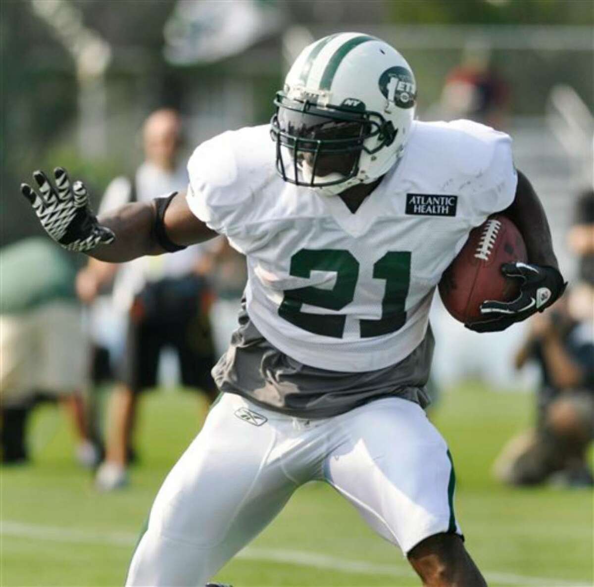 New York Jets running back LaDainian Tomlinson carries the ball during morning practice at the team's NFL football training camp in Cortland, N.Y., Tuesday, Aug. 3, 2010. (AP Photo/Kevin Rivoli)