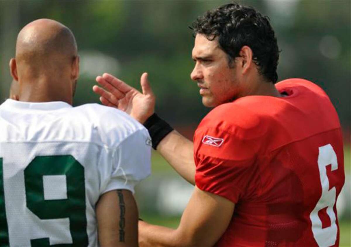 New York Jets quarterback Mark Sanchez, right, talks with receiver Laveranues Coles during morning practice at the team's NFL football training camp in Cortland, N.Y., Tuesday, Aug. 3, 2010. (AP Photo/Kevin Rivoli)
