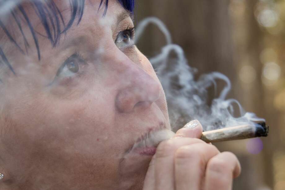 Carrie Bassett of Phoenix, Arizona smokes a marijuana joint in the consumption area of Grass Lands at Outside Lands in Golden Gate Park in San Francisco, Calif. on August 9, 2019. Photo: Douglas Zimmerman/SFGate.com