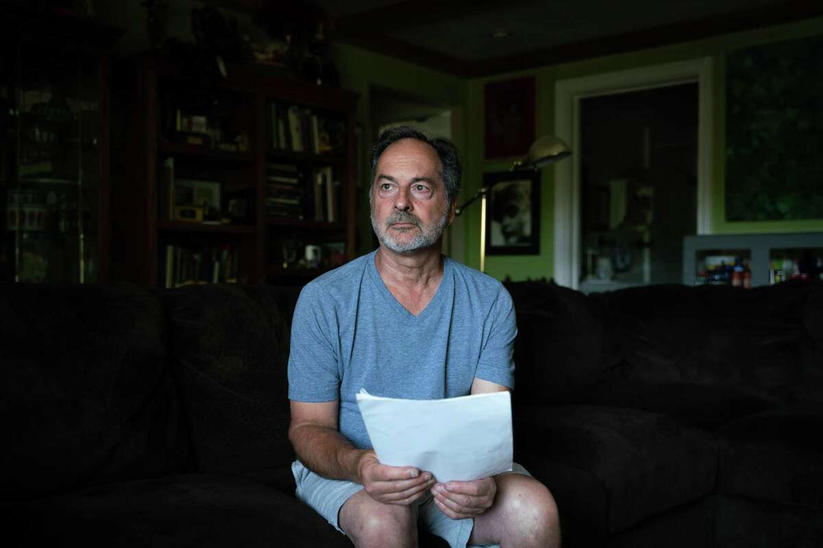 Joey Piscitelli, 64, poses for a portrait holding court documents at his home in Martinez, Calif., on Wednesday, July 31, 2019. Piscitelli was sexually abused at the Boys Club in Richmond when he was 13-years-old. Then he was abused by a priest who was also the vice principal of his high school in Berkeley. Piscitelli said it took him 30 years to speak publicly about his abuse and that he knows some victims "who never will."