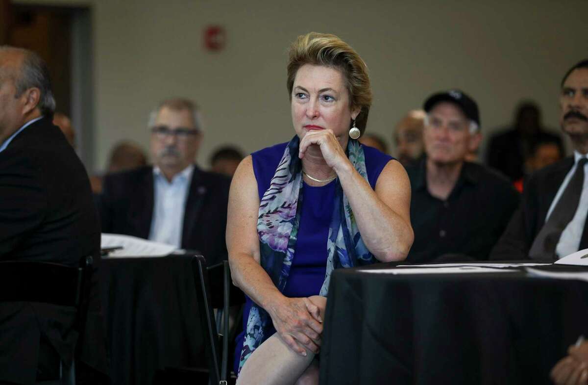 Harris County District Attorney Kim Ogg listens to bureau chiefs from the Harris County District Attorney's office speak about their roles during a community meeting on Saturday, Aug. 10, 2019, in Houston.