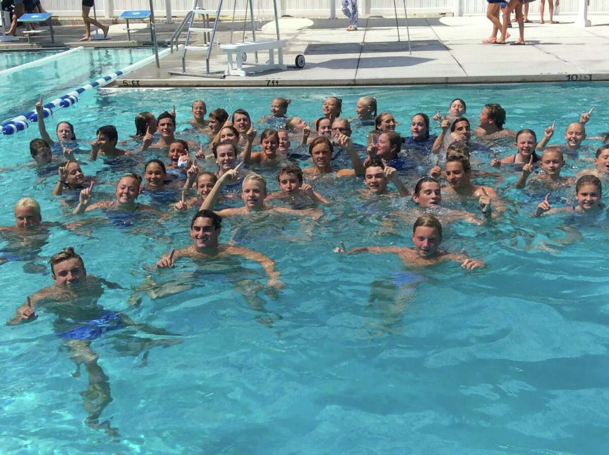 Members of the Rocky Point Club swimming team celebrate in the pool at Roxbury Swim & Tennis Club after they won the team title at the Fairfield County Swim League Championships on Saturday, Aug. 10, 2019, in Stamford, Connecticut.