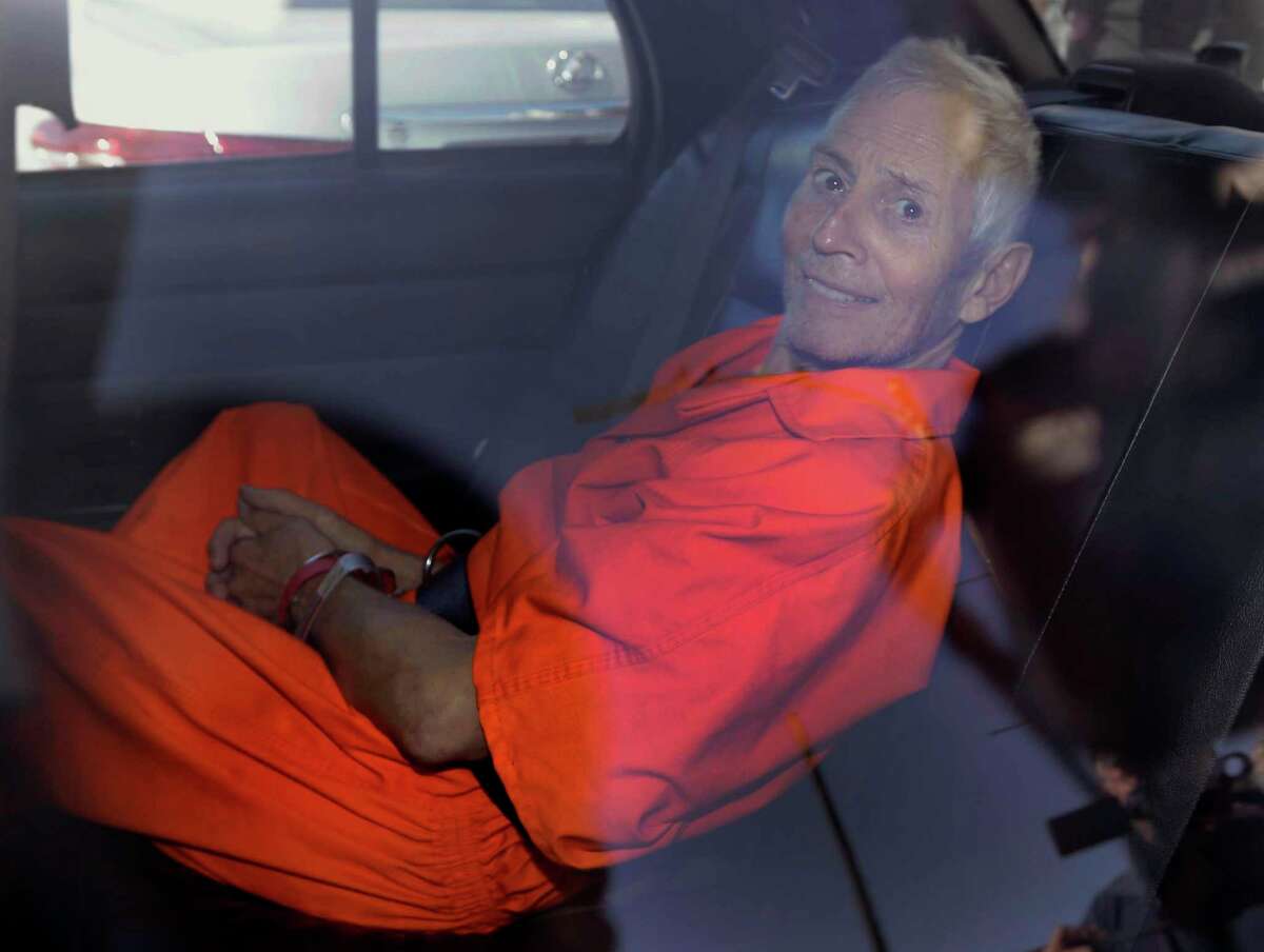 FILE - In this Tuesday, March 17, 2015, file photo, Robert Durst is transported from Orleans Parish Criminal District Court to the Orleans Parish Prison after his arraignment in New Orleans. The whispered words of Durst recorded in an unguarded moment in a bathroom could come back to haunt him - or help him - as he faces a murder charge. A possible move by prosecutors to introduce the incriminating material from a six-part documentary on his strange life and connection to three killings could back fire as interview footage did in the Michael Jackson molestation trial and the Robert Blake murder case.