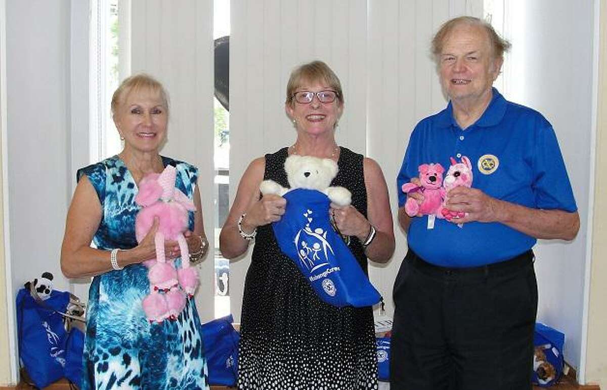 Nick Percival, president of the Exchange Club of Ridgefield (XCR), presents the club’s gift of 18 tote bags to Pat Zachman, center, president and CEO of the Women’s Center of Greater Danbury. Dyane MacDaniel-Brandt, a member Exchange Club of Ridgefield and current president emeritus of Ridgefield’s Meals on Wheels, helps with the toting.