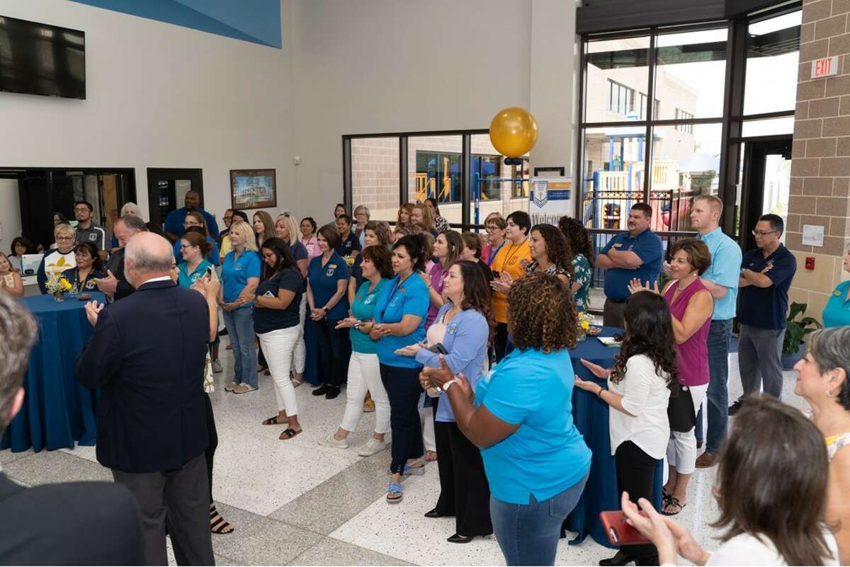 Pearland city and business officials and staff members attend a recent ribbon-cutting ceremony for the renovated St. Helen Educational Building, which houses St. Helen Catholic School.