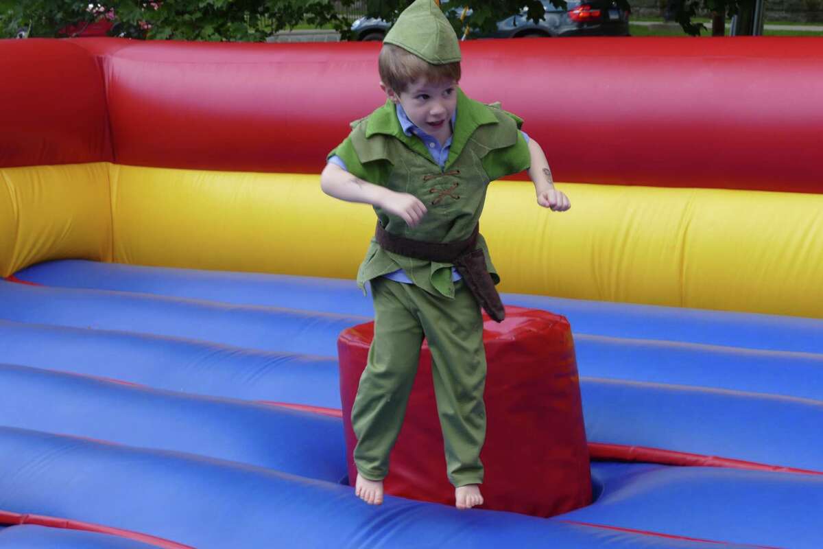 Connor Maxwell, dressed as Peter Pan, bounces around the inflatable bouncy house at the fifth annual RidgeCon on Saturday, Aug. 10.