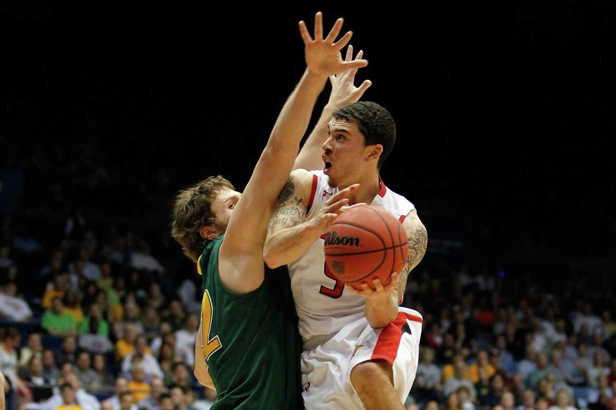 DAYTON, OH - MARCH 14: Mike James #5 of the Lamar Cardinals drives for a shot attempt in the second half against Ben Crenca #42 of the Vermont Catamounts in the first round of the 2011 NCAA men's basketball tournament at UD Arena on March 14, 2012 in Dayton, Ohio. (Photo by Gregory Shamus/Getty Images)