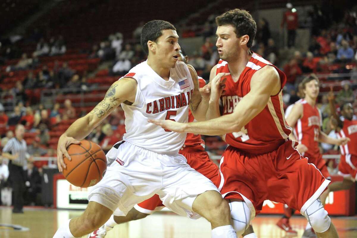Lamar guard Mike James, left, tries to drive around Nicholls State defender Ben Martin, right, in the first half of their game at the Montagne Center on Saturday, February 12, 2011. Valentino Mauricio/The Enterprise
