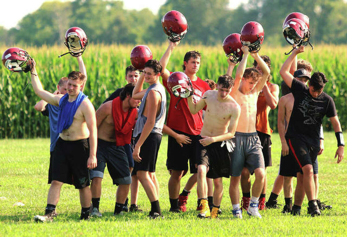 Bunker Hill players break from a huddle after skill position drills for a water break during the first day of practice Monday at Bunker Hill High School. The Minutemen are preparing for their first season of eight-man football.