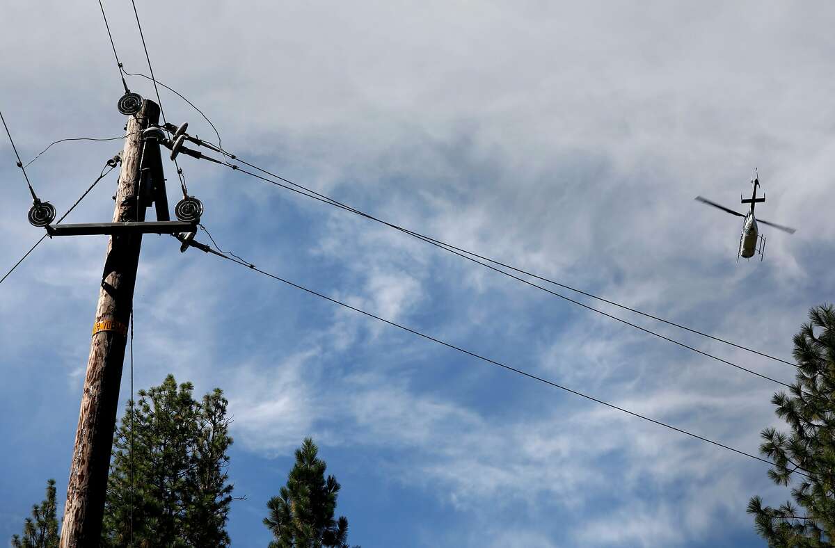 A PG&E helicopter flies 300 feet above inspecting power lines, as PG&E performs a public safety power shutoff drill around Foresthill, Ca. on Thurs. August 8, 2019, Helicopters and trucks, are used in a trial run for how it will inspect power lines before turning them on after a shut down.