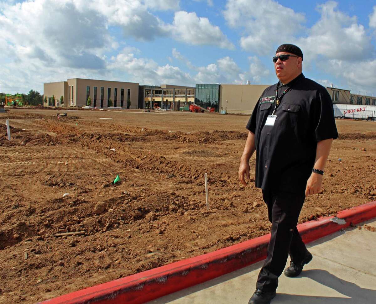 Kofi Taharka, chairman of the Houston chapter of the National Black United Front, walks past a Fort Bend school construction site where the skeletal remains of 95 convict laborers were discovered last year.