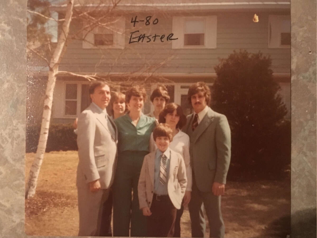 Rev. Francis P. Melfe, who left the priesthood the year before, poses with Edith Thomas and their five children, including his biological son, in Easter 1980 in front of their Debutante Manor house in Guilderland.