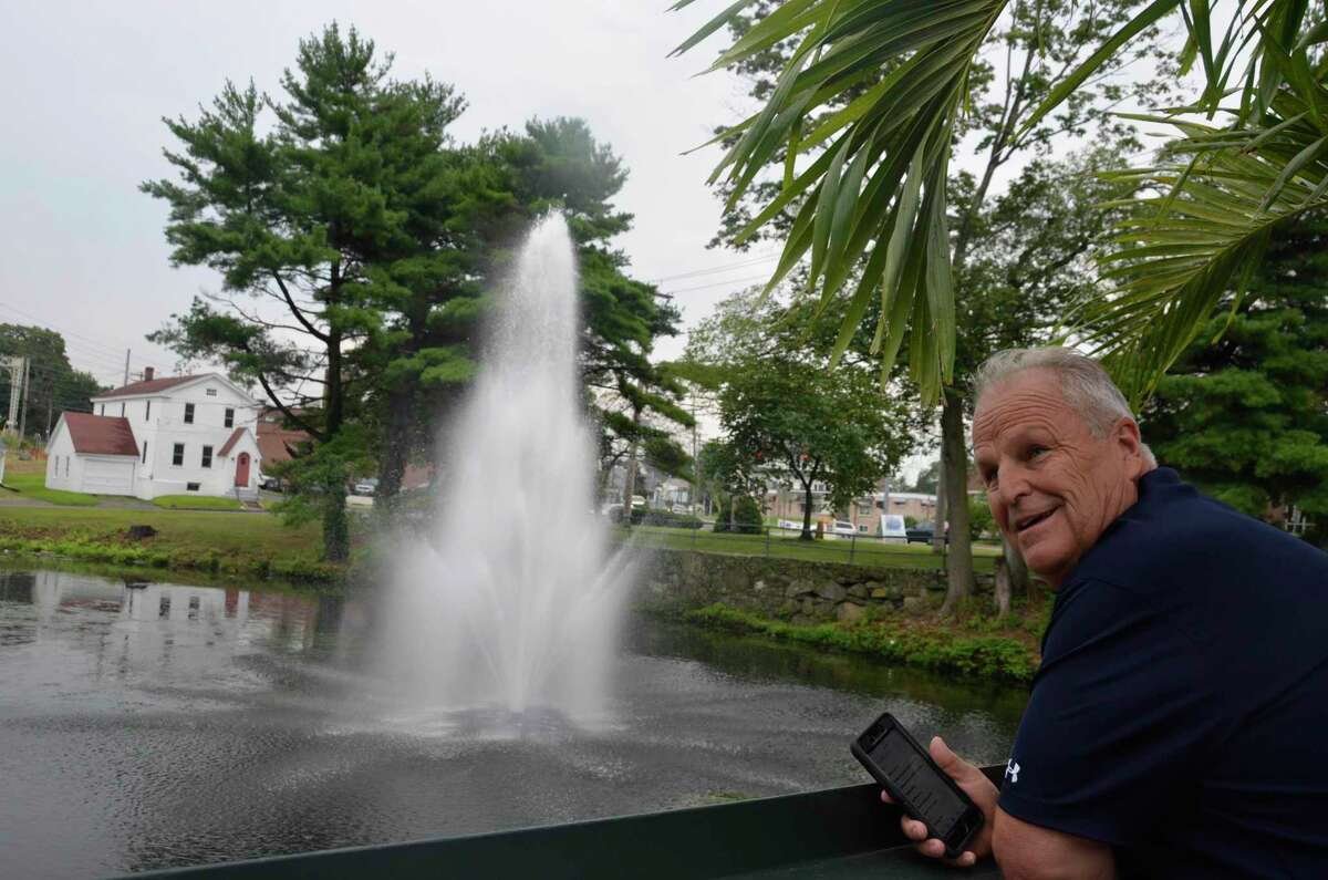 Rich Conine, owner of Stonebridge Restaurant, looks at the fountain he had placed in the pond behind his restaurant Aug. 13, 2019.