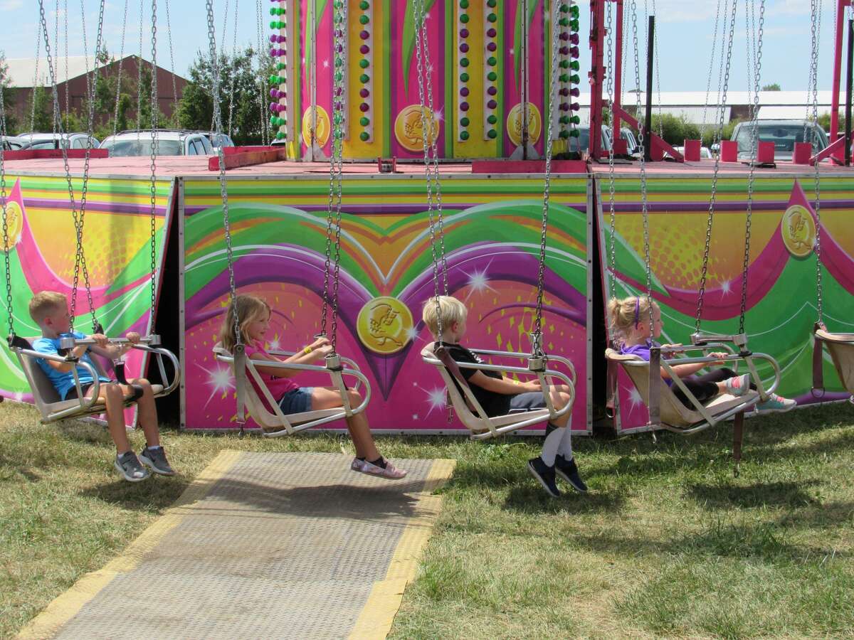 Visitors enjoy the attractions, rides and food that the Midland County Fair has to offer on Tuesday, Aug. 13, 2019.