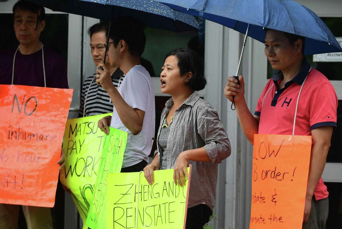 Flushing Workers Center organizer Sarah Ahn joins protestors to protest the firing two Matsu Sushi staff members during a picket of the restaurant on Tuesday in Westport. The two employees, Jianming Jiang and Liguo Ding, were fired in 2017 after they refused to work three consecutive shifts.