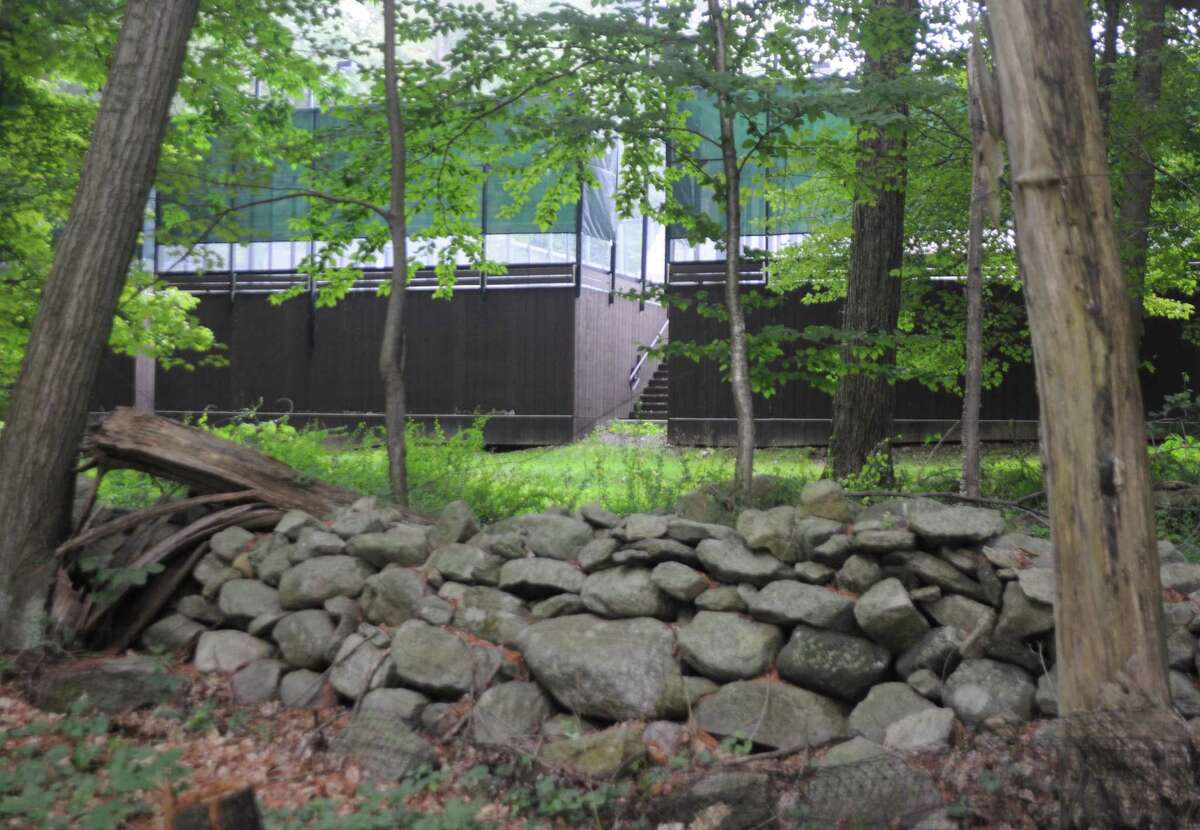 The paddle tennis courts at Silver Spring Country Club are just 45 feet form the property line of the nearest neighbors, marked by the sonte wall. The club got a approval to move the courts so they'll be more than 900 feet from the closest home.