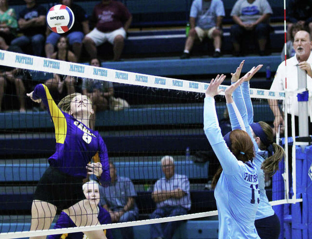 Civic Memorial’s Sydney Henke (left) hits over a double block put up by the Jersey Panthers in a Mississippi Valley Conference volleyball match last season at Havens Gym in Jerseyville. The 6-foot senior is back to lead the Eagles after earning first-team All-MVC honors as a junior.