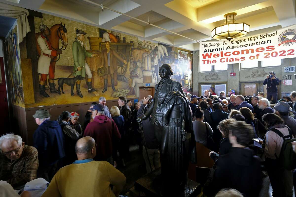 FILE - In this Aug. 1, 2019, file photo, people fill the main entryway of George Washington High School to view the controversial 13-panel, 1,600-square foot mural, the "Life of Washington," during an open house for the public in San Francisco. San Francisco Unified School District Board of Education President Stevon Cook says he plans to introduce a solution at the school board meeting Tuesday, Aug. 13, 2019, to cover the "Life of Washington" mural without destroying it. Cook says he will propose covering the mural with panels that contain artwork that shows "the heroism of people of color in America, how we have fought against, and continue to battle discrimination, racism, hatred, and poverty." 