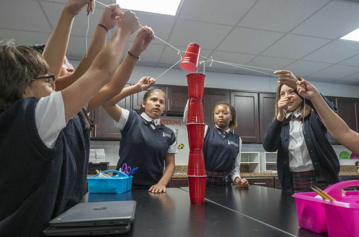 Students in a STEM class use teamwork to build a tower made of cups 08/14/19 morning for the first day at the new Young Women's Leadership Academy. Tim Fischer/Reporter-Telegram