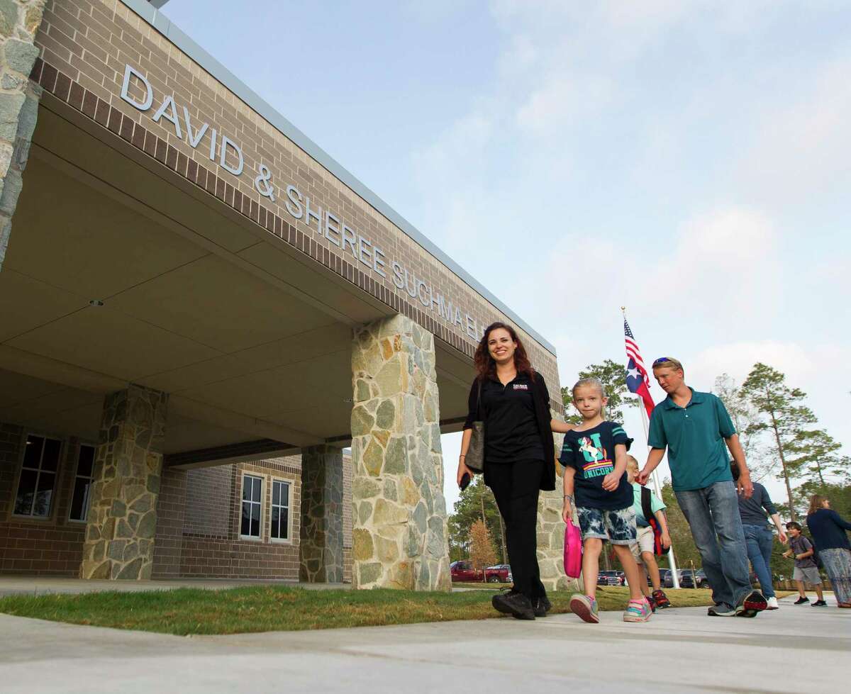 Students walk toward the newly opened Suchma Elementary on the first day of school for Conroe ISD, Wednesday, Aug. 14, 2019, in Conroe.