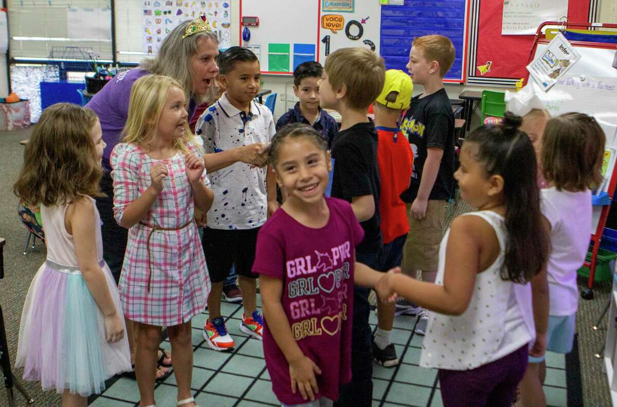 Children in first grade teacher Michelle Brown’s classroom turn to shake hands during the first day of school Wednesday, August 14, 2019 at CC Hardy Elementary School in Willis.