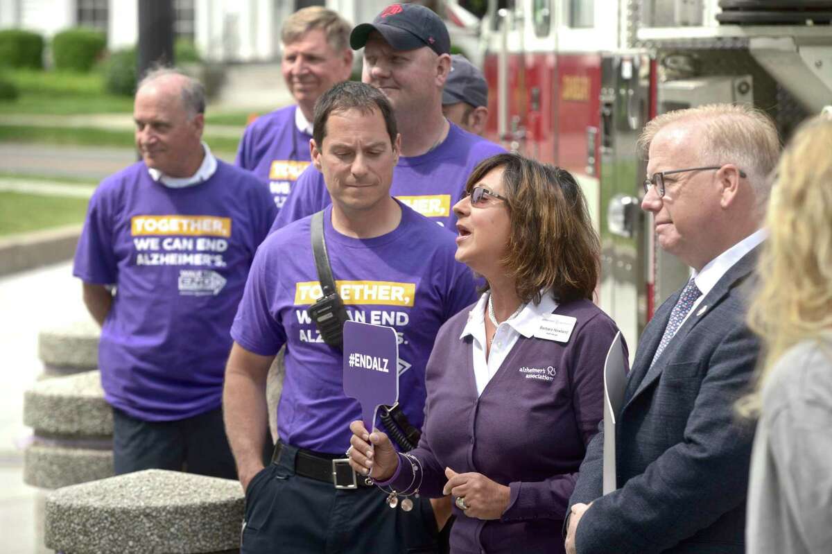 Barbara Newland, center, Walk Manager at the Alzheimer's Association, speaks during the kick off of Alzheimer's & Brain Awareness Month at City Hall, Wednesday morning, June 5, 2019, in Danbury, Conn. This years Walk to End Alzheimer's is September 22.