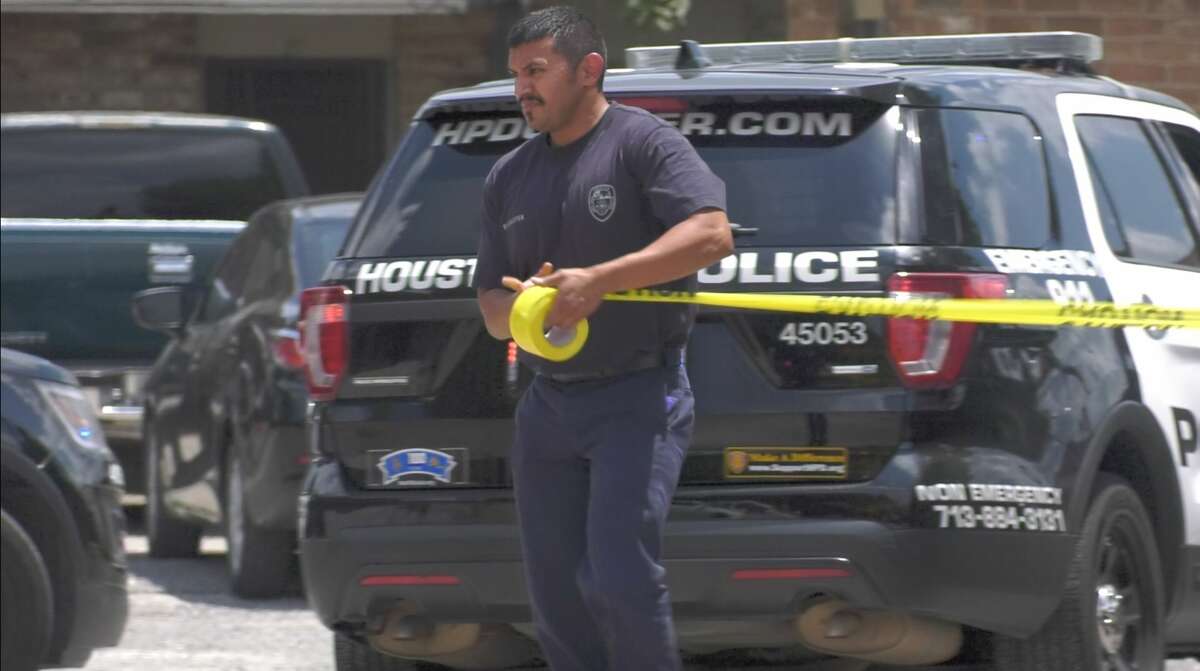 Houston police officers investigate a deadly auto-pedestrian collision inside the parking lot of a southeast Houston apartment complex Wednesday, Aug. 14, 2019.