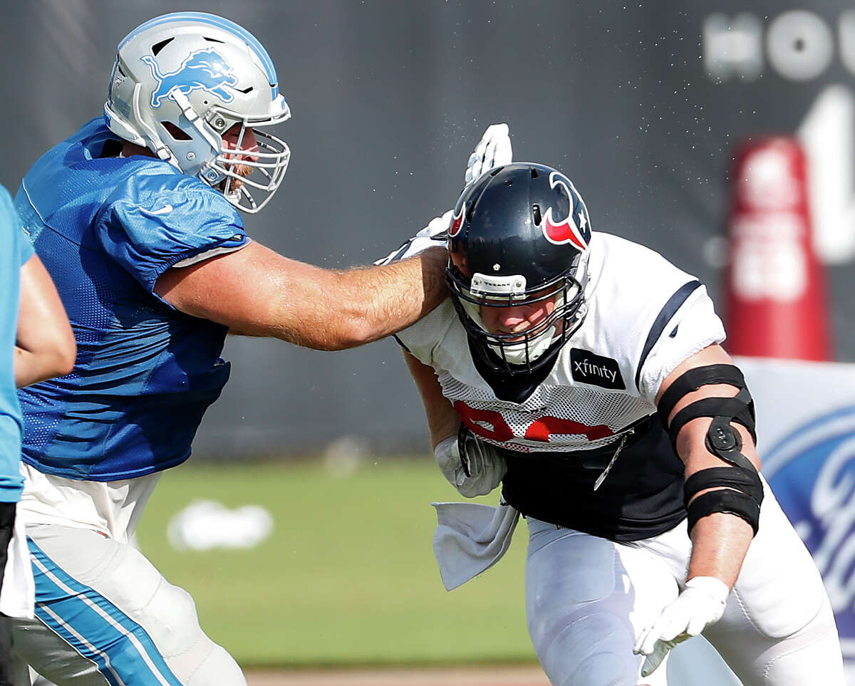 Houston Texans defensive end J.J. Watt (99) runs past Detroit Lions offensive tackle Rick Wagner (71) during a joint training camp practice at the Houston Methodist Training Center on Wednesday, Aug. 14, 2019, in Houston.