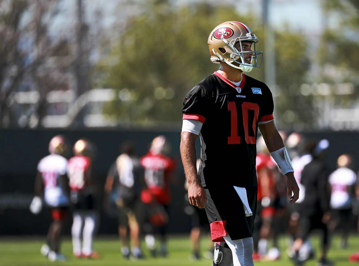 San Francisco 49ers quarterback Jimmy Garoppolo passes the football as he  practices on the field during San Francisco 49ers 2020 Training Camp  practice at the SAP Performance Facility at Levi's Stadium on