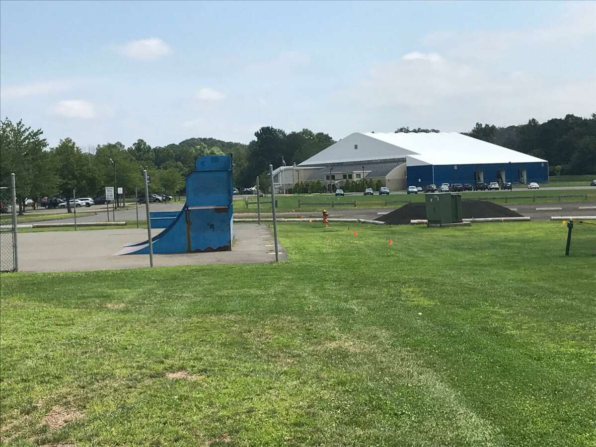 A view of a portion of the Bartlem Park recreation complex in Cheshire, including a skateboard park in the foreground and the town’s Community Pool in the background.