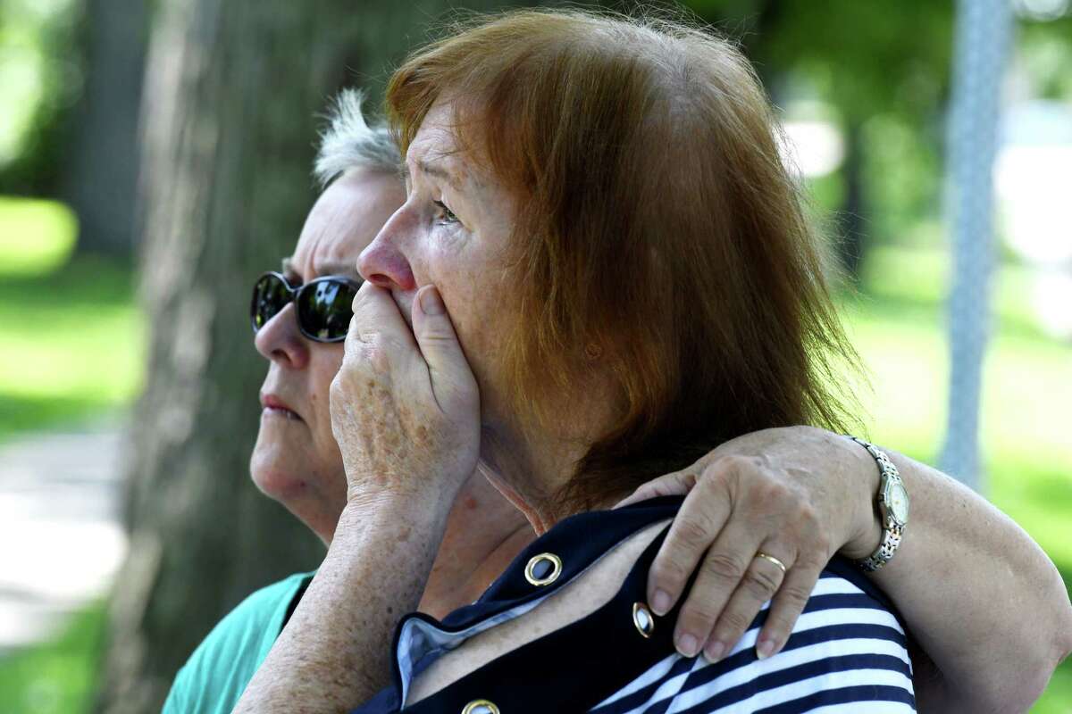 Child Victims Act sexual abuse plaintiff Susanne Robertson, right, is comforted by her cousin, Mary Slater, left, during a news conference announcing three lawsuits to be filed against the Albany Catholic Diocese on Wednesday, Aug. 14, 2019, outside the Diocese of Albany offices in Albany, N.Y. Robertson alleges she was abused at the St. Colman's Home in the 1960s. (Will Waldron/Times Union)