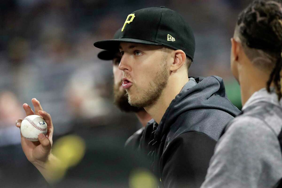 Pittsburgh Pirates starting pitcher Jameson Taillon, center, sits in the dugout during a baseball game against the New York Mets in Pittsburgh, Friday, Aug. 2, 2019.