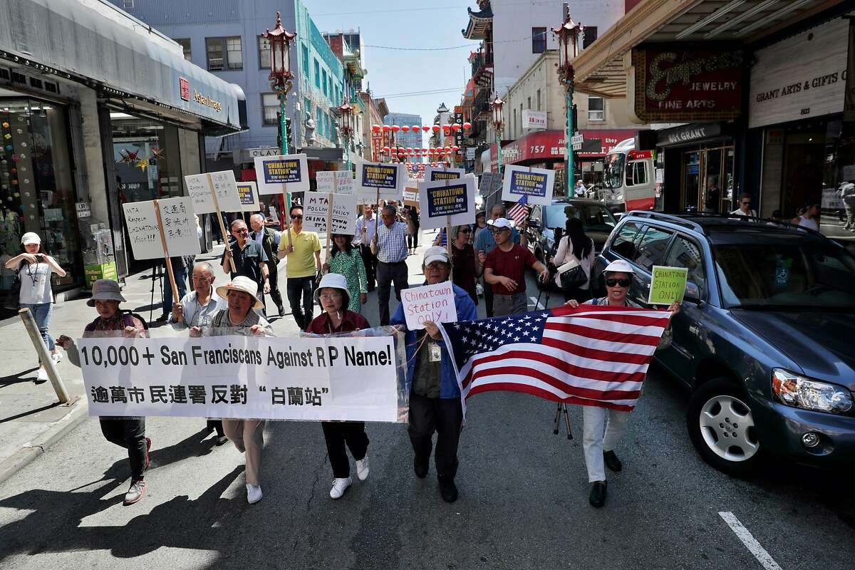 Local residents march on Grant Avenue in San Francisco, Calif., on Wednesday, August 14, 2019, as the Chinatown Merchants Association(CMA) held a public event to protest the proposal before the SFMTA to place Rose Pak’s name on the Central Subway Chinatown station.