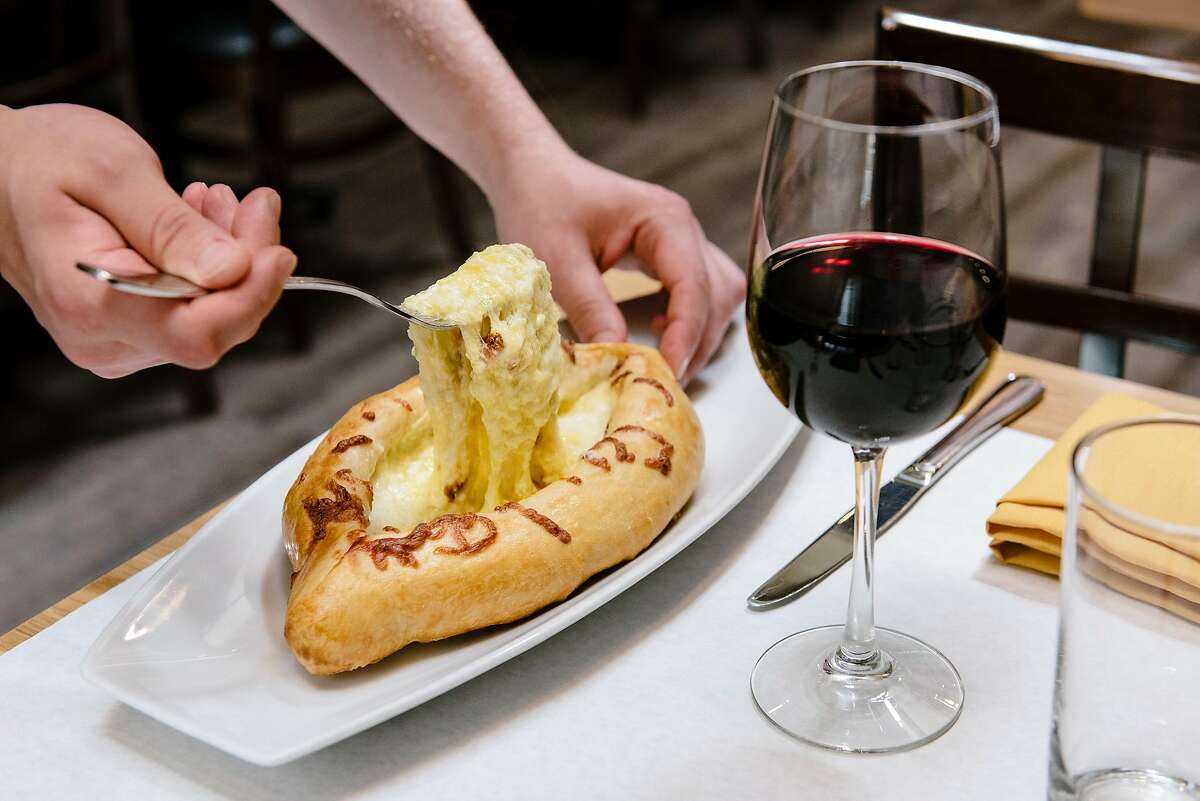 The khachapuri adrjaruli, a boat shaped bread with cheese, butter and an egg served in the middle and stirred together before eating, at Bevri restaurant in Palo Alto, Calif, on Tuesday, August 13, 2019.