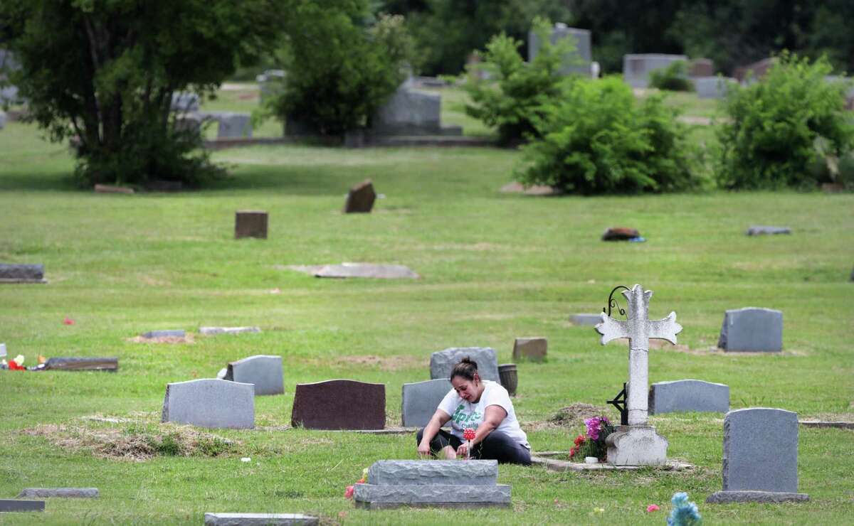 Sandra Lee Hernandez, 39, visits the grave of her mother, Maria Elena Hernandez, when things trouble her, at The Southern Memorial Eastview Cemetery. The cemetery, once over grown and in decay, is being restored to a sacred resting place that it once was. Vera Williams-Young, owner of Carter-Taylor-Williams Funeral Home, became the new curator and with the help of volunteers, has restored the burial ground to a place of honor that she remember visiting as a child.