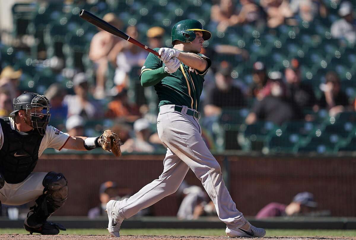 SAN FRANCISCO, CA - AUGUST 14: Corban Joseph #56 of the Oakland Athletics hits a sacrifice fly scoring Mark Canha #20 against the San Francisco Giants in the top of the ninth inning at Oracle Park on August 14, 2019 in San Francisco, California. (Photo by Thearon W. Henderson/Getty Images)