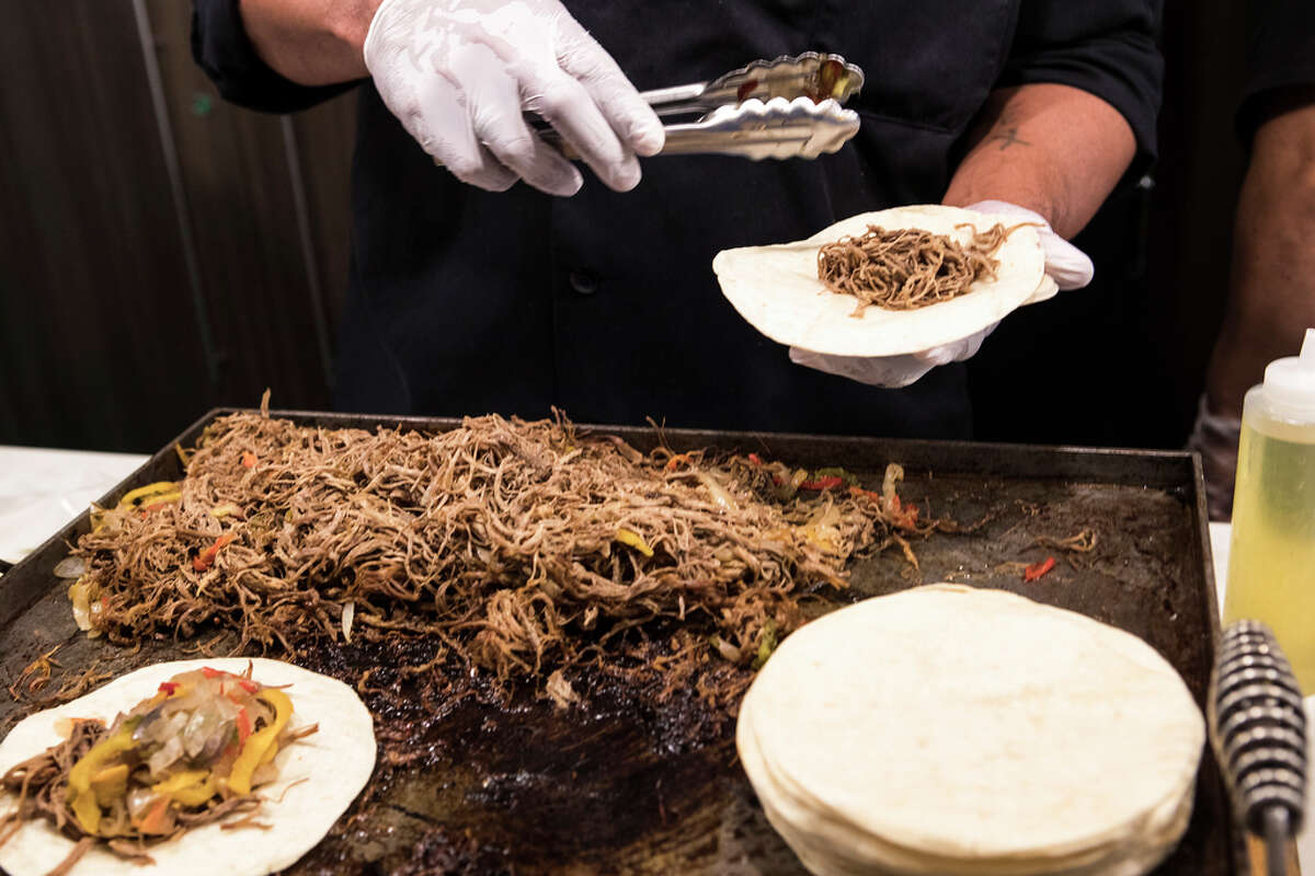 The Original Ninfa's Beef Brisket Tinga (Sections 309, 336) Beef tinga tacos - slow braised brisket served with sour cream, cheddard cheese, pico de gallo on your choice of tortillas, nacho chips or nacho salad bowl - are made during the What's New at NRG Stadium event on Thursday, Aug. 15, 2019 in Houston .
