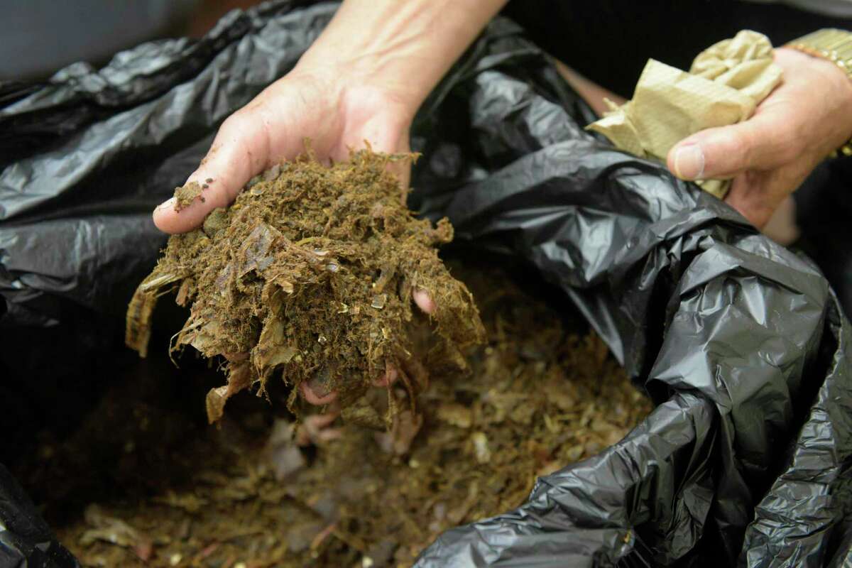 Kerry Gold, Director of Dinning Services at New Milford Hospital, shows compost produced by the Somat Pulper DS100 in his kitchen. The machine takes 300 pounds of kitchen waste and turns it into 30 pounds of compost. Wednesday afternoon, August 14, 2019, in New Milford, Conn.